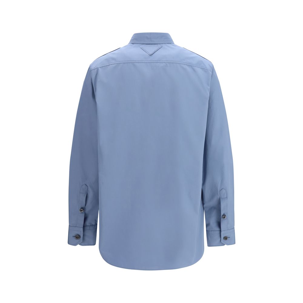 Prada — Chemise en popeline de coton bleu (Oversize)
Cette chemise en popeline