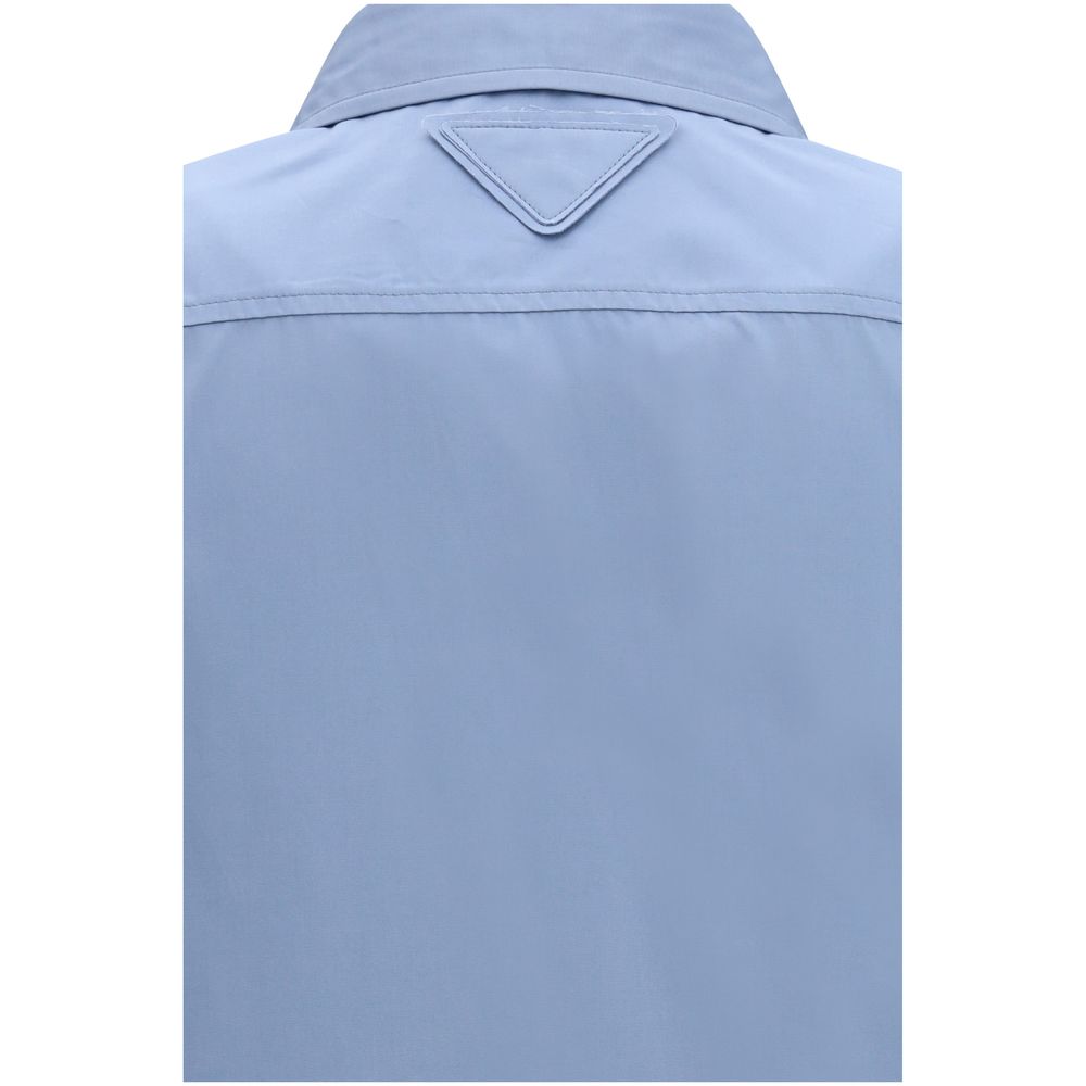 Prada — Chemise en popeline de coton bleu (Oversize)
Cette chemise en popeline