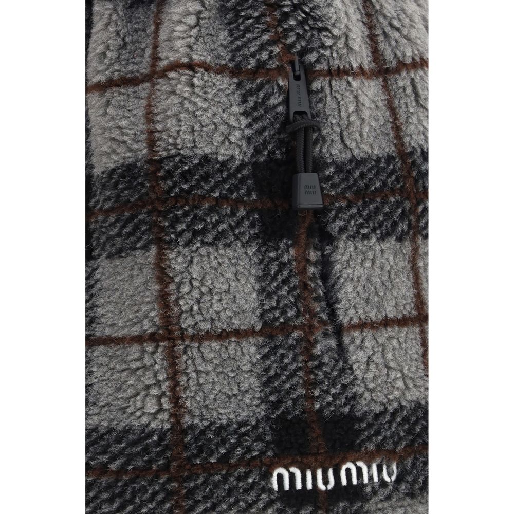 Miu Miu – Mini-jupe à carreaux avec logo brodé