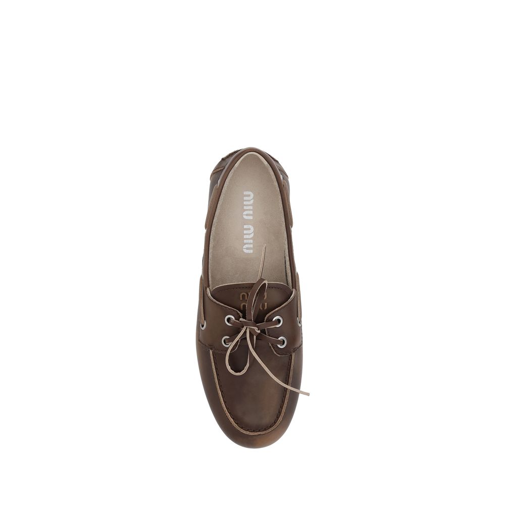 Miu Miu – Loafers bateau en cuir effet vieilli